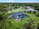 Aerial view of a house with a screened pool, and large landscaped yard at 104 Amberwood Ct, Longwood, FL 32779