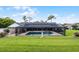 Lovely home boasts a serene pool, expansive lawn, screened-in lanai, and beautifully manicured landscape at 104 Amberwood Ct, Longwood, FL 32779