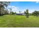 Expansive backyard showcasing a lush lawn, mature trees, and a well-maintained home exterior at 104 Amberwood Ct, Longwood, FL 32779