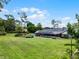 Expansive backyard featuring a screened pool, lush lawn, and mature landscaping at 104 Amberwood Ct, Longwood, FL 32779