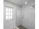 Elegant bathroom features a glass-enclosed shower with beautiful stone flooring and a door leading to the outside at 104 Amberwood Ct, Longwood, FL 32779