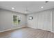 Spacious bedroom with light, airy feel, wood-look floors, shutters, and large closet at 104 Amberwood Ct, Longwood, FL 32779