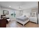 Clean and bright bedroom with wood-look floors, ceiling fan, and neutral decor at 104 Amberwood Ct, Longwood, FL 32779