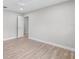 Empty bedroom with wood-look floors, neutral paint, and white doors and trim at 104 Amberwood Ct, Longwood, FL 32779