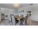 Open dining area with view to the living room featuring modern decor and a chandelier at 104 Amberwood Ct, Longwood, FL 32779