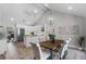 Open concept dining area with pendant lighting, vaulted ceilings, and a view to the modern kitchen at 104 Amberwood Ct, Longwood, FL 32779