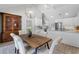 Open kitchen design with stainless steel appliances, white cabinets, and a dining area at 104 Amberwood Ct, Longwood, FL 32779
