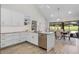 Bright kitchen with white cabinets, stainless steel appliances, and a view of the dining area at 104 Amberwood Ct, Longwood, FL 32779
