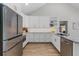 Contemporary kitchen featuring white cabinets, stainless steel appliances and marble countertops at 104 Amberwood Ct, Longwood, FL 32779