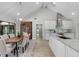 Spacious kitchen with white cabinets, stainless steel appliances, open to the dining area and backyard at 104 Amberwood Ct, Longwood, FL 32779