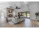 Living room featuring a brick fireplace, wood floors and vaulted ceilings with backyard views at 104 Amberwood Ct, Longwood, FL 32779