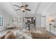 Bright living room featuring a ceiling fan, modern furniture, and sliding glass doors to a covered patio at 104 Amberwood Ct, Longwood, FL 32779