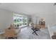 Bright living room with neutral walls and a large window with grid design overlooking the front yard at 104 Amberwood Ct, Longwood, FL 32779
