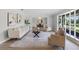 Bright and airy living room featuring a large window and stylish decor, open to the dining area at 104 Amberwood Ct, Longwood, FL 32779