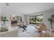 Bright living room featuring wood floors, a large window with backyard views and neutral colored furniture at 104 Amberwood Ct, Longwood, FL 32779