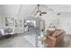 Bright living room featuring vaulted ceilings, modern furniture, and sliding glass doors to a covered patio at 104 Amberwood Ct, Longwood, FL 32779