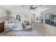 Bright main bedroom with vaulted ceilings, ceiling fan, sliding doors to patio, and sitting area at 104 Amberwood Ct, Longwood, FL 32779