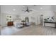 Bright main bedroom with vaulted ceilings, ceiling fan, shuttered windows, and sitting area at 104 Amberwood Ct, Longwood, FL 32779