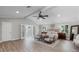 Bright main bedroom with vaulted ceilings, ceiling fan, shuttered windows, and sitting area at 104 Amberwood Ct, Longwood, FL 32779