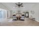 Spacious main bedroom with a ceiling fan, neutral color palette, wood-look tile flooring, and sitting area at 104 Amberwood Ct, Longwood, FL 32779