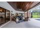 Beautifully designed outdoor patio featuring a ceiling fan, brick accents, and cozy seating area at 104 Amberwood Ct, Longwood, FL 32779