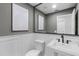 Clean powder room with modern fixtures, wainscoting, art and a large mirror at 104 Amberwood Ct, Longwood, FL 32779