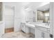 Bright bathroom featuring double sinks, a vanity area, a large mirror, and a tiled shower at 1091 Wood Dale Cir, Oviedo, FL 32765