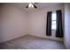 Bright bedroom with carpet, a ceiling fan, and a window with blue curtains at 1091 Wood Dale Cir, Oviedo, FL 32765