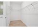 A tidy walk-in closet has wire shelving and light, wood-look flooring at 1091 Wood Dale Cir, Oviedo, FL 32765