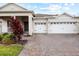 Charming single-Gathering home showcasing a three-car garage and neatly landscaped front yard at 1091 Wood Dale Cir, Oviedo, FL 32765