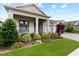 A charming single-Gathering home featuring beautiful landscaping, a cozy porch, and a brick-paved driveway at 1091 Wood Dale Cir, Oviedo, FL 32765