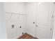 This laundry room has wood-look floors, a wire shelf and a white door at 1091 Wood Dale Cir, Oviedo, FL 32765