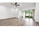 Spacious living room features tile floors, a modern ceiling fan and sliding glass doors at 1091 Wood Dale Cir, Oviedo, FL 32765