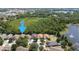 This aerial view showcases the property's location near a serene lake and verdant green spaces at 11236 Rouse Run Cir, Orlando, FL 32817