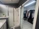 Bathroom features a tiled walk-in shower and doorway leading to the walk-in closet at 11236 Rouse Run Cir, Orlando, FL 32817