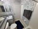 Bathroom featuring a vanity, toilet, towel and blue rug against patterned wallpaper at 11236 Rouse Run Cir, Orlando, FL 32817