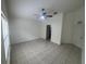 Spacious bedroom featuring tile floors, and a ceiling fan that will keep you cool and comfortable at 11236 Rouse Run Cir, Orlando, FL 32817