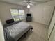 This bedroom offers tile floors, a ceiling fan, and a window with blinds to filter natural sunlight at 11236 Rouse Run Cir, Orlando, FL 32817