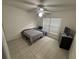 Bright bedroom with tile flooring, ceiling fan, and window providing natural light and fresh air at 11236 Rouse Run Cir, Orlando, FL 32817