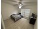 Bedroom with tile flooring, ceiling fan, and a bed and dresser against one wall at 11236 Rouse Run Cir, Orlando, FL 32817