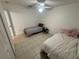Bright bedroom with tile flooring, featuring two twin beds and a ceiling fan at 11236 Rouse Run Cir, Orlando, FL 32817