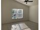 Bedroom featuring tile floors, a large window for natural light, and neutral walls at 11236 Rouse Run Cir, Orlando, FL 32817