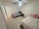 Tiled bedroom featuring two twin beds, a ceiling fan, and plenty of space for comfortable living at 11236 Rouse Run Cir, Orlando, FL 32817
