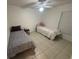 Bedroom with two twin beds, neutral walls, tile floors, and a ceiling fan at 11236 Rouse Run Cir, Orlando, FL 32817
