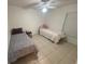 Tiled bedroom featuring two twin beds, a ceiling fan, and plenty of space for comfortable living at 11236 Rouse Run Cir, Orlando, FL 32817