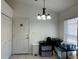 Bright dining area with tile flooring, featuring a modern light fixture and neutral decor at 11236 Rouse Run Cir, Orlando, FL 32817