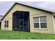 Back exterior featuring a screened in porch area, ideal for enjoying the outdoors at 11236 Rouse Run Cir, Orlando, FL 32817