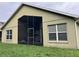 Exterior view of the house showing a screened in porch and backyard at 11236 Rouse Run Cir, Orlando, FL 32817