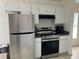 Modern kitchen with stainless steel appliances and white cabinetry, offering a functional cooking space at 11236 Rouse Run Cir, Orlando, FL 32817