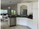 A view of the kitchen with stainless steel appliances and white cabinetry at 11236 Rouse Run Cir, Orlando, FL 32817